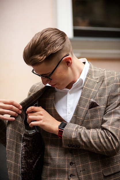 Young men in classic clothes communicate on the street