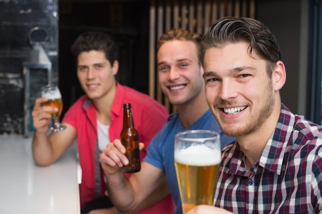 Young men drinking beer together