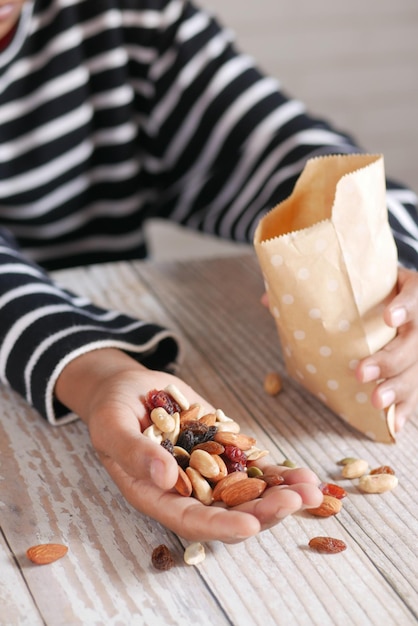 Young men eating many mixed nuts