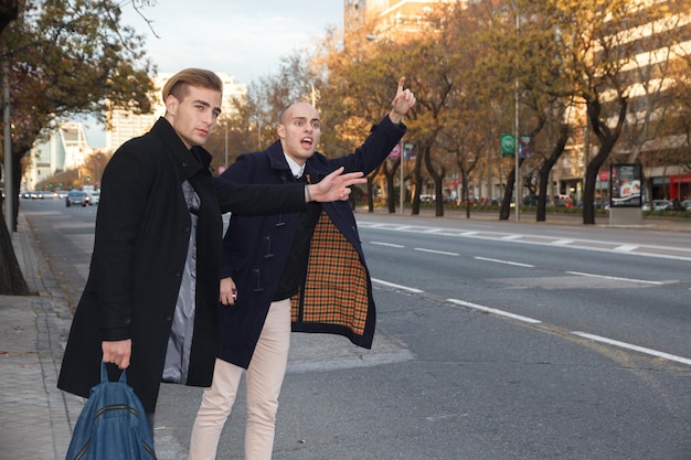 Young men hailing a taxi