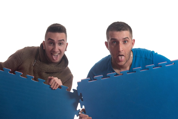 Young Men Holding Blue Tatami Mat Puzzle