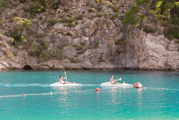 Young men sailing in a canoe