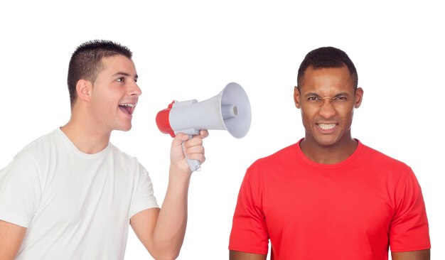 Young men screams to his angry friend through a megaphone 