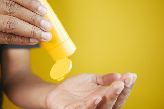 Young men using sunscreen cream