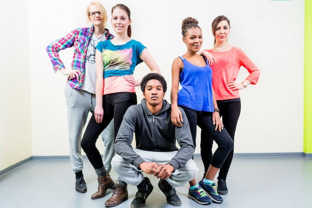 Young men and women in dance class posing