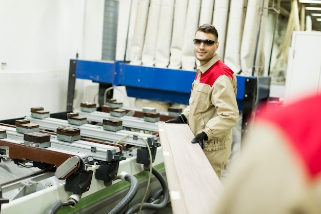 Young men working in furniture factory