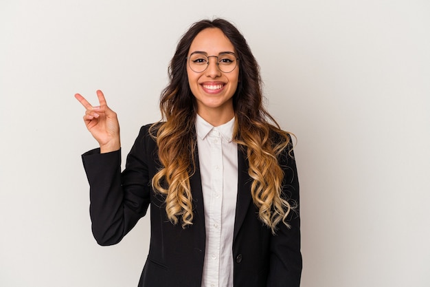 Young mexican business woman isolated on white background joyful and carefree showing a peace symbol with fingers.