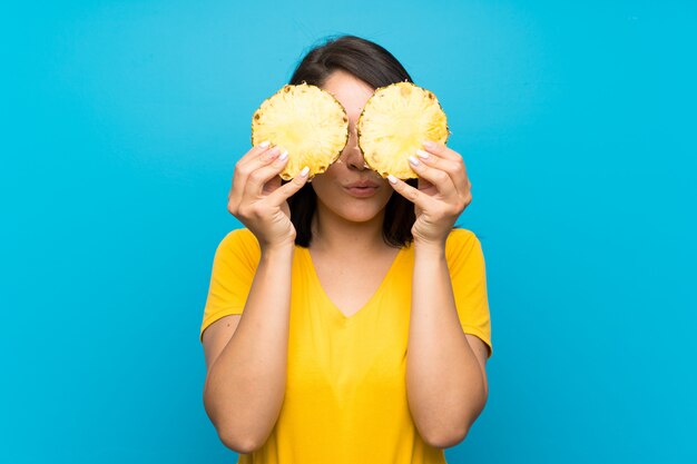 Young Mexican woman  on blue 