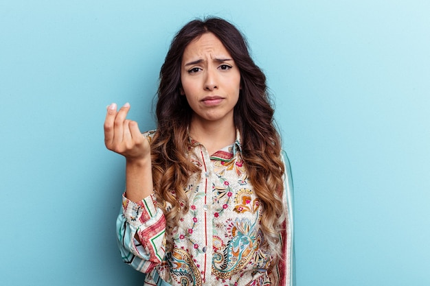 Young mexican woman isolated on blue background showing that she has no money.