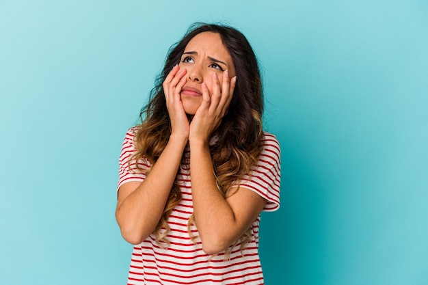 Young mexican woman isolated on blue background whining and crying disconsolately.