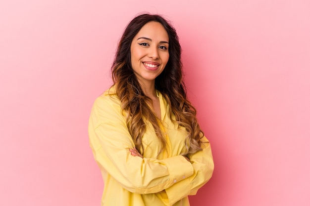 Young mexican woman isolated on pink background happy, smiling and cheerful.