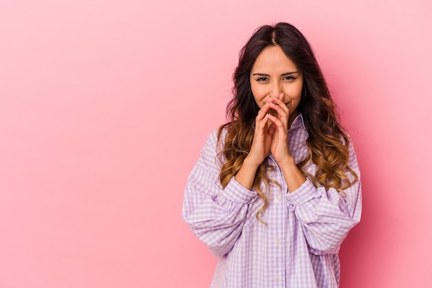 Young mexican woman isolated on pink background making up plan in mind, setting up an idea.