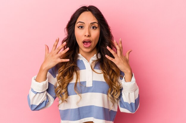 Young mexican woman isolated on pink background showing number ten with hands.
