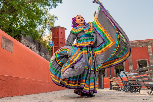 Young mexican woman in a traditional folklore dress of many colors traditional dancer