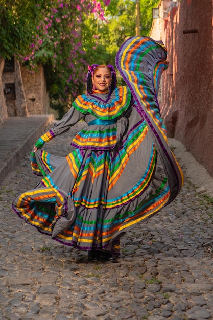 Young mexican woman in a traditional folklore dress of many colors traditional dancer