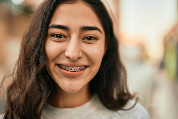 Young middle east girl smiling happy standing at the city.