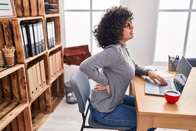 Young middle east woman business worker suffering for backache working at office