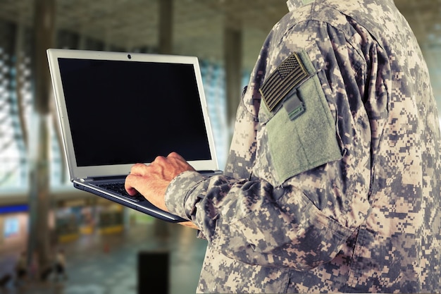 young military soldier man portrait with laptop
