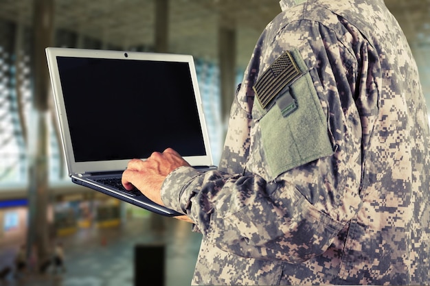 Young military soldier man portrait with laptop