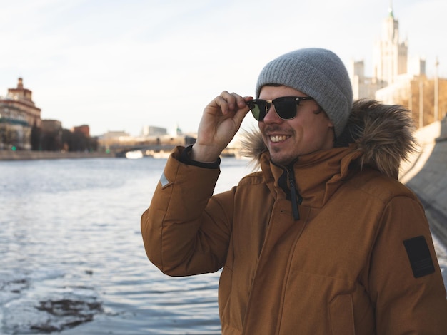 Young millennial male wearing sunglasses smiling face