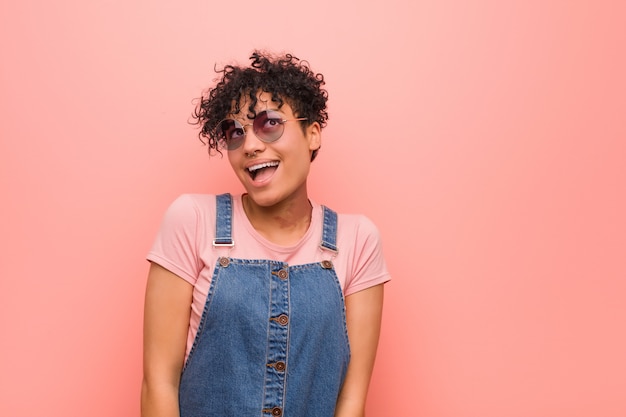 Young mixed african american teenager woman dreaming of achieving goals and purposes