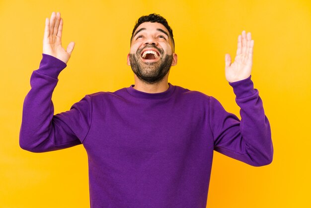 Young mixed race arabic man isolated screaming to the sky,\
looking up, frustrated.