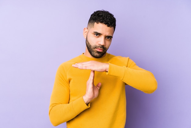 young mixed race arabic man showing a timeout gesture.