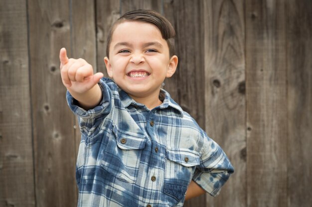 Young Mixed Race Boy Making Shaka Hand Gesture