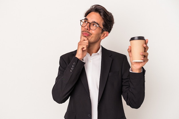 Young mixed race business man holding take away coffee  isolated on white background looking sideways with doubtful and skeptical expression.