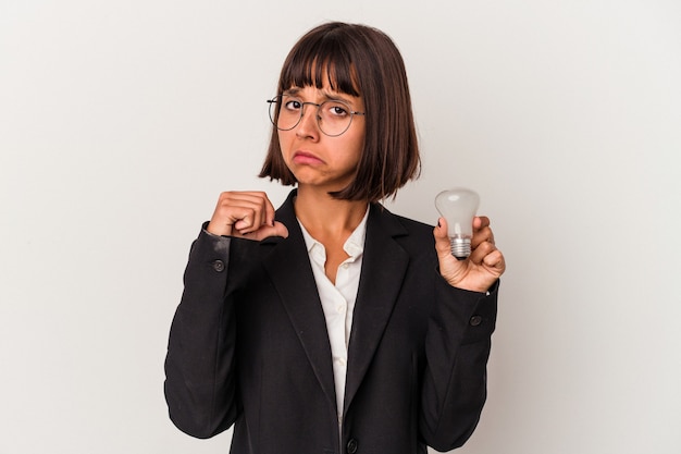 Young mixed race business woman holding a light bulb isolated on white background feels proud and self confident, example to follow.