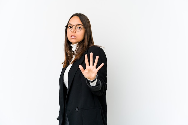 Young mixed race business woman isolated on white background being shocked due to an imminent danger