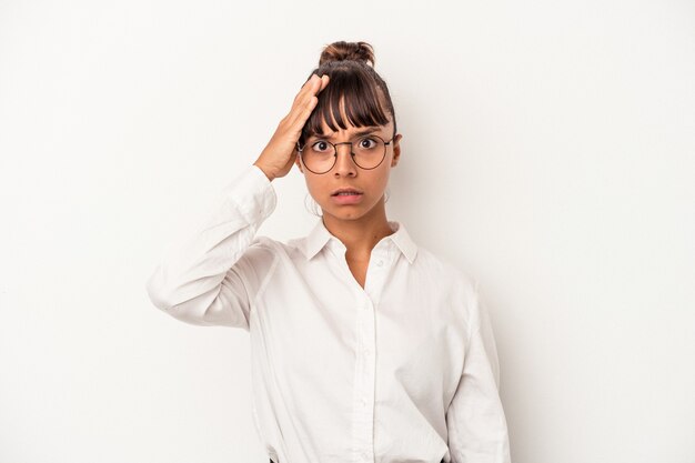 Young mixed race business woman isolated on white background  being shocked, she has remembered important meeting.