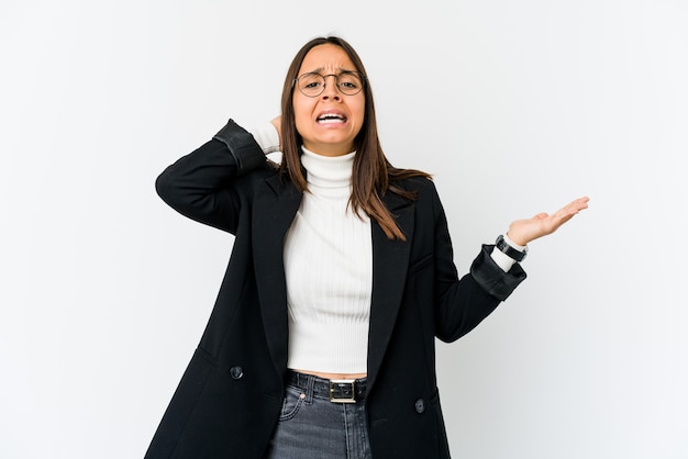 Young mixed race business woman isolated on white background screaming with rage.