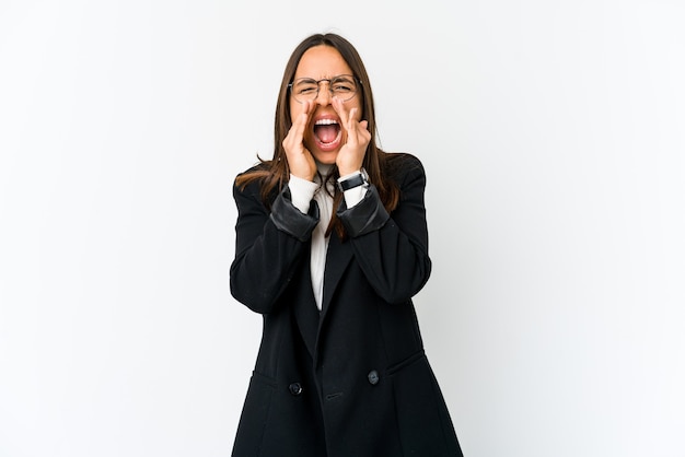 Young mixed race business woman isolated on white background shouting excited to front.