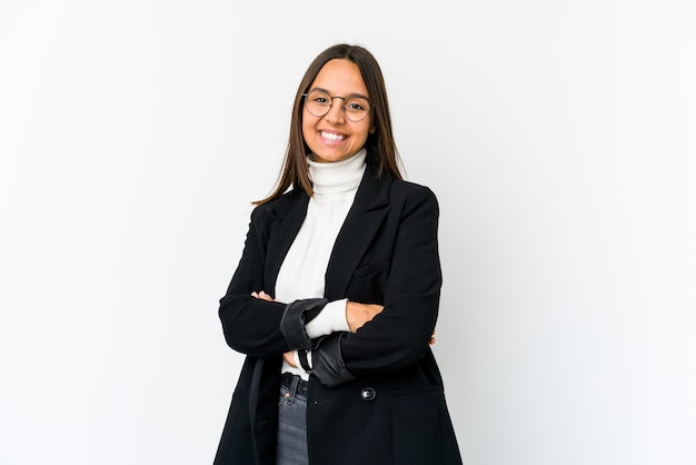 Young mixed race business woman isolated on white background who feels confident, crossing arms with determination.