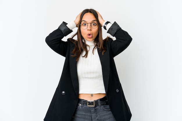 Young mixed race business woman isolated on white being shocked, she has remembered important meeting.