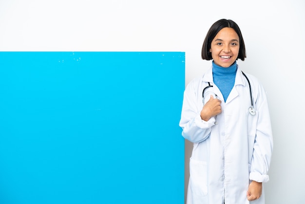 Young mixed race doctor woman with a big placard isolated on white background with surprise facial expression