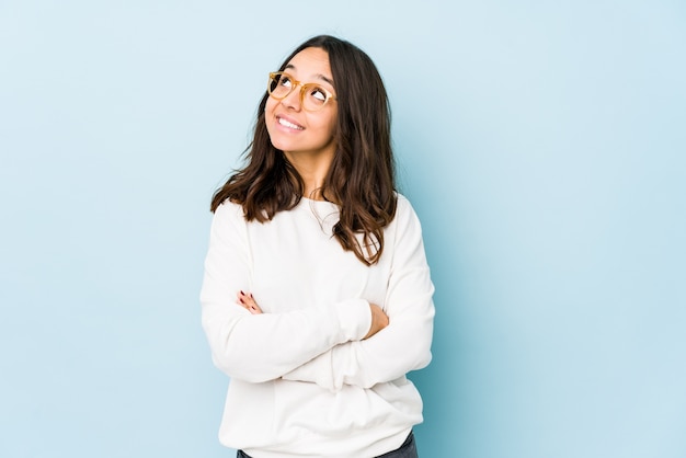 Young mixed race hispanic woman isolated dreaming of achieving goals and purposes