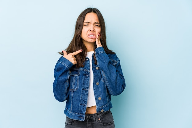 Young mixed race hispanic woman isolated having a strong teeth pain, molar ache.