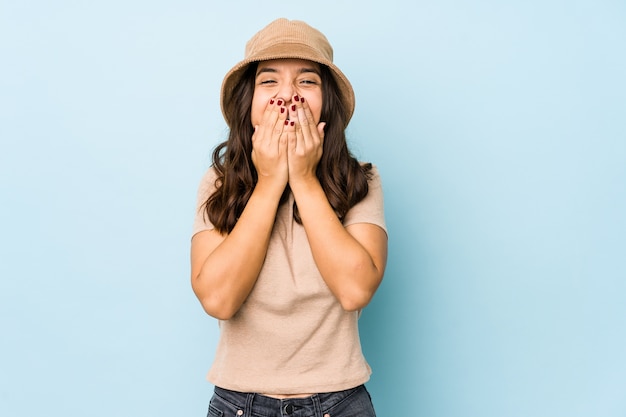 Young mixed race hispanic woman isolated laughing about something, covering mouth with hands.