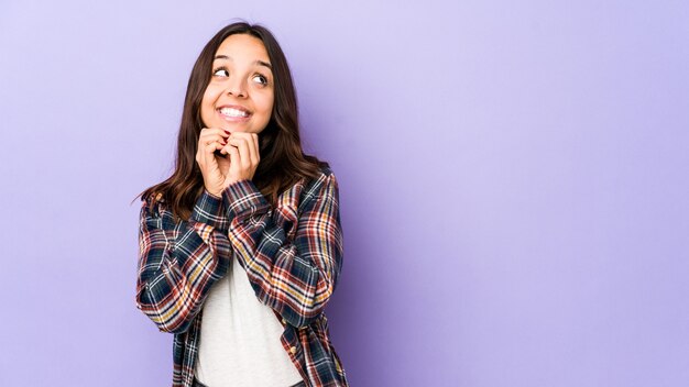 Young mixed race hispanic woman isolated making up plan in mind, setting up an idea.