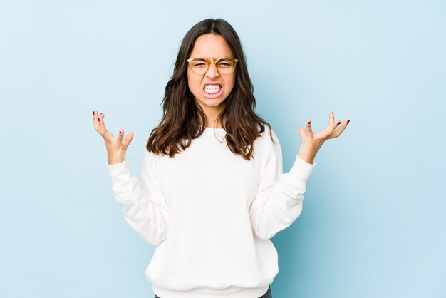 Young mixed race hispanic woman isolated screaming with rage.