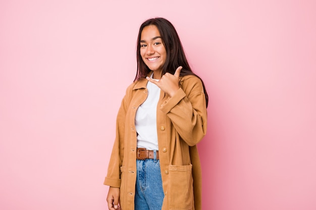 Young mixed race indian woman isolated showing a mobile phone call gesture with fingers.