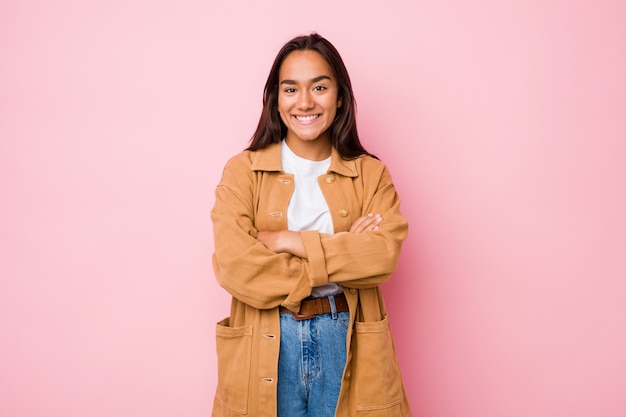 Young mixed race indian woman who feels confident, crossing arms with determination.