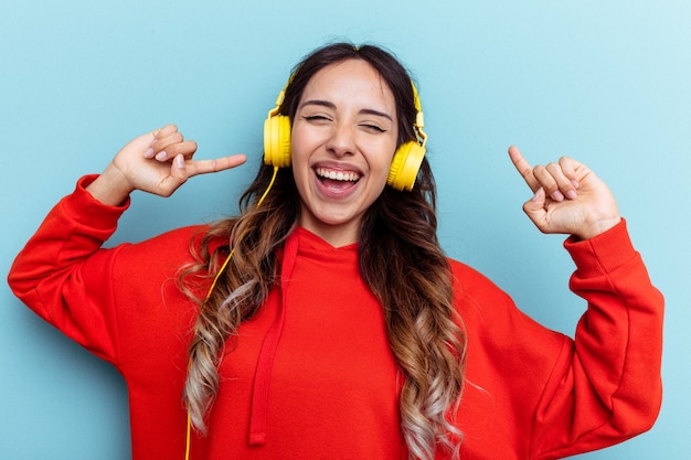 Young mixed race listening to music with headphones