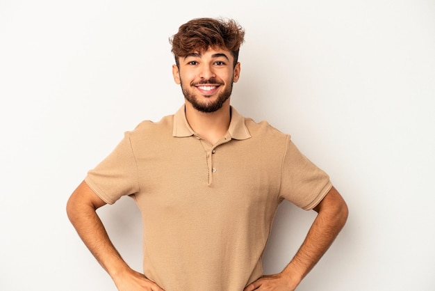 Young mixed race man isolated on grey background confident keeping hands on hips.