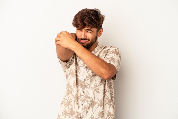 Young mixed race man isolated on grey background having a neck pain due to stress, massaging and touching it with hand.