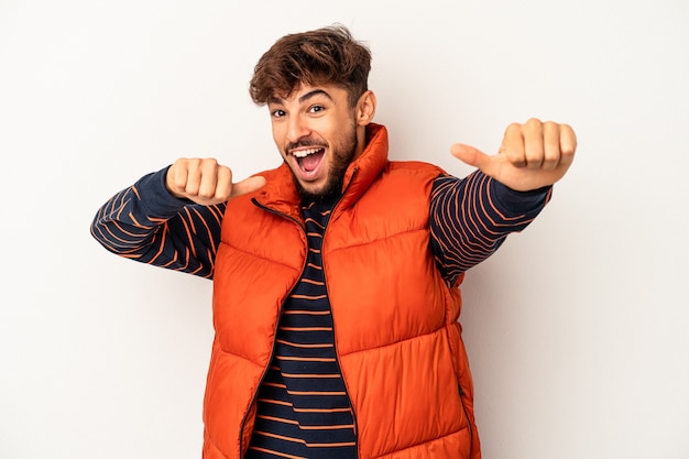 Young mixed race man isolated on grey background raising both thumbs up, smiling and confident.