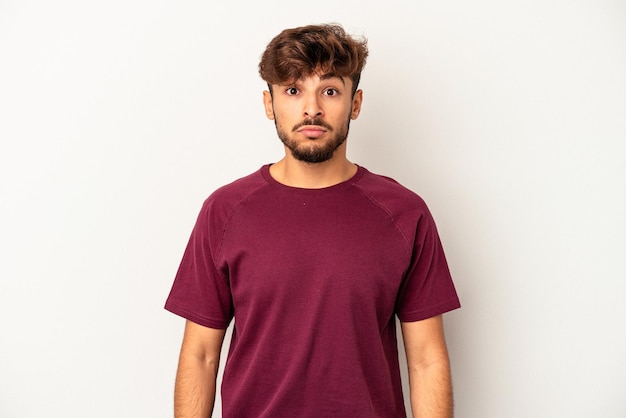 Young mixed race man isolated on grey background sad, serious face, feeling miserable and displeased.