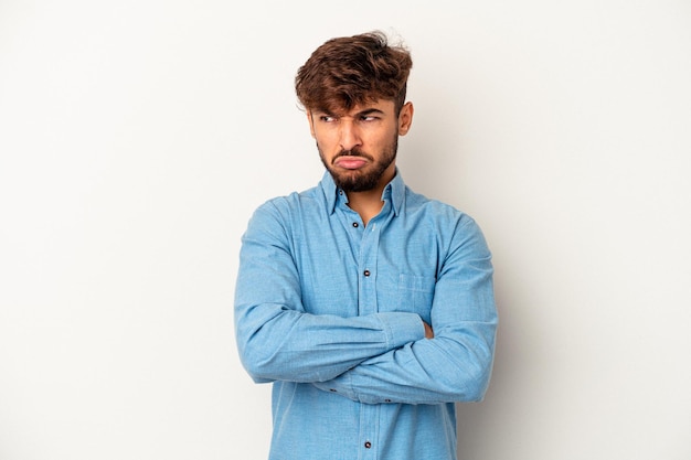Young mixed race man isolated on grey background tired of a repetitive task.